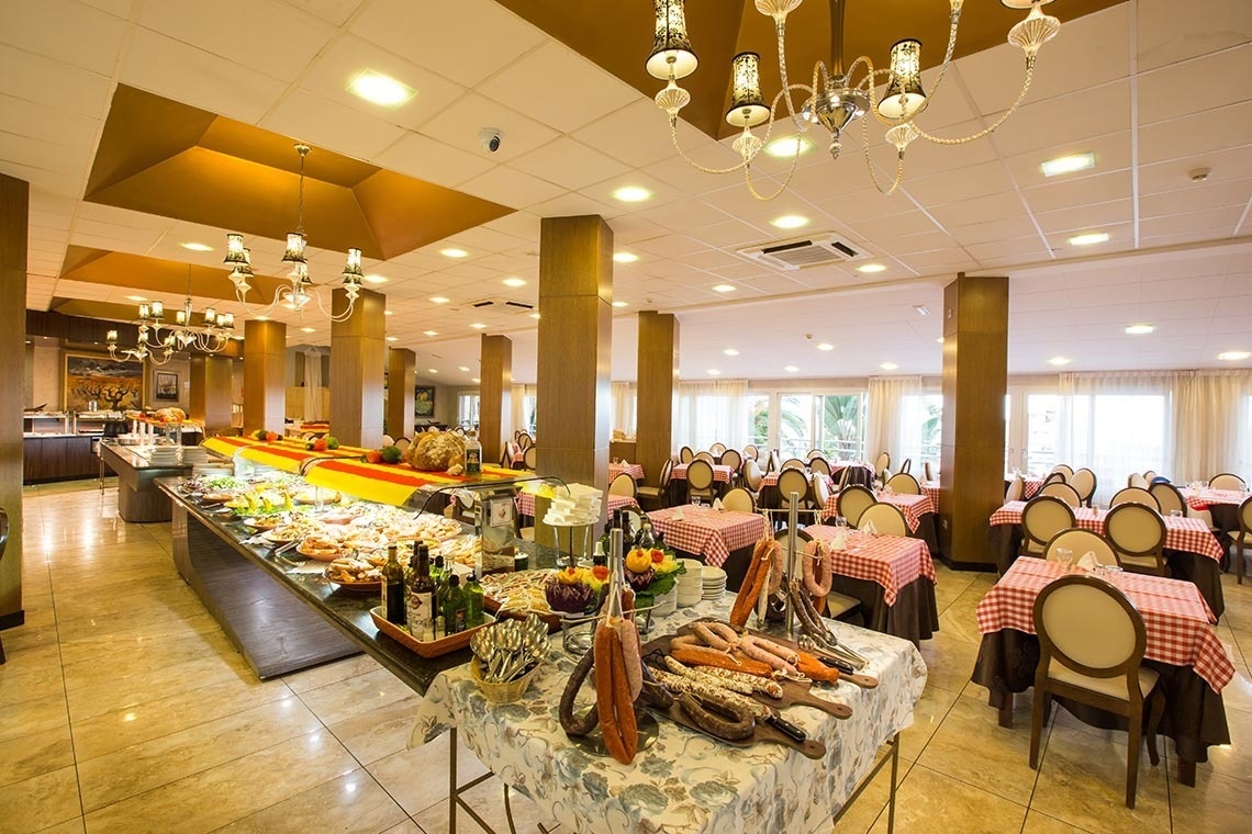 a buffet in a restaurant with tables and chairs