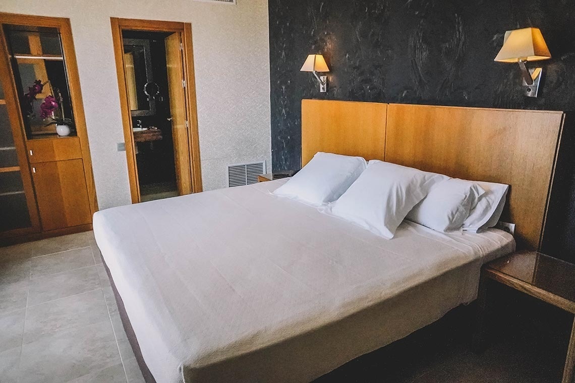 una habitación de hotel con una cama y dos lámparas