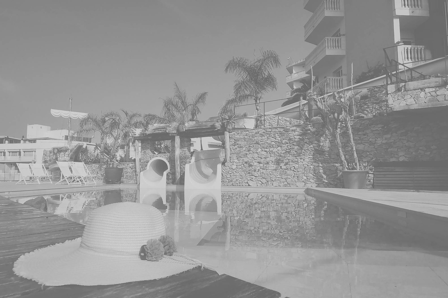 a black and white photo of a large white building with a balcony=s1900