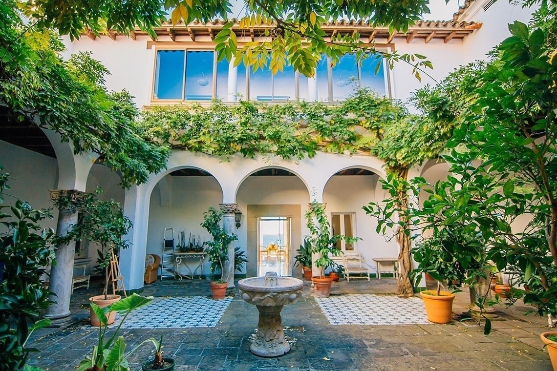 tables and chairs in a restaurant with a view of the ocean