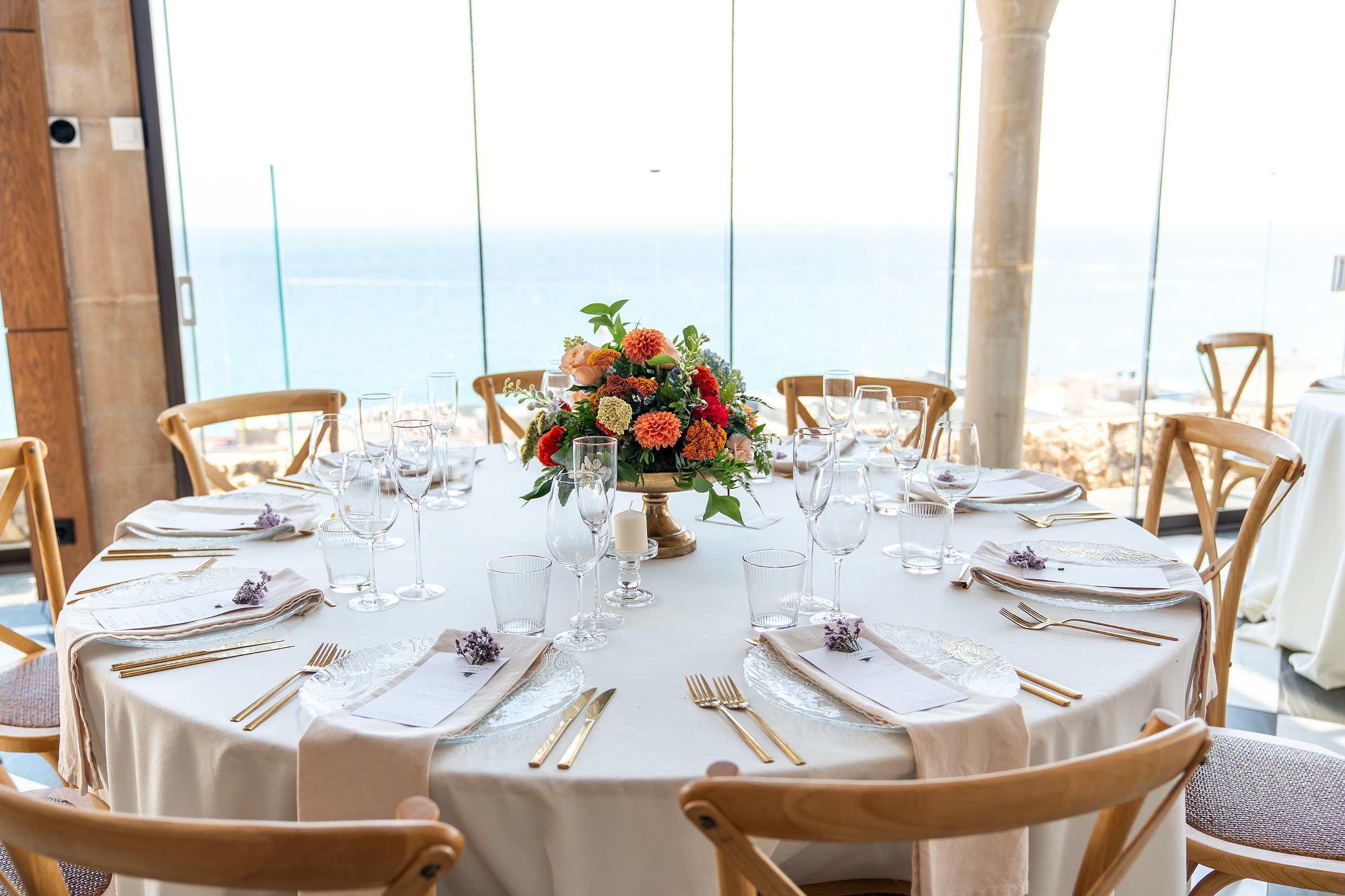 Elegant table setting at Roger De Flor By Seleqtta with flowers and sea view.