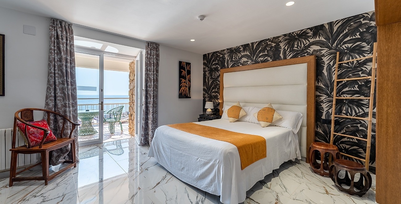 a bedroom with a large bed and a balcony