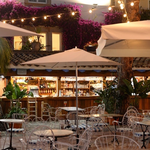 un restaurante al aire libre con mesas y sillas y paraguas