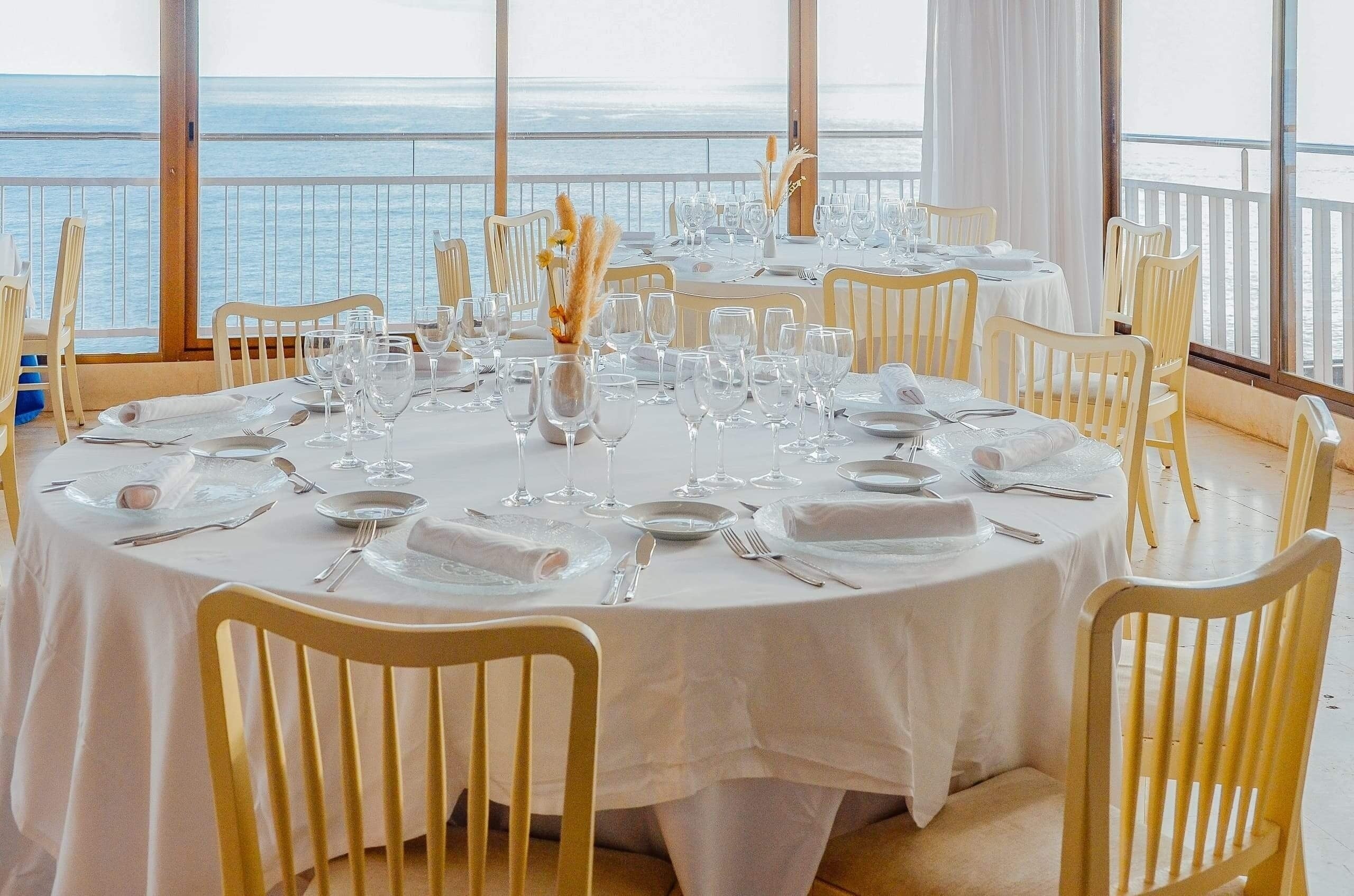 a bar with stools and bottles of liquor on shelves