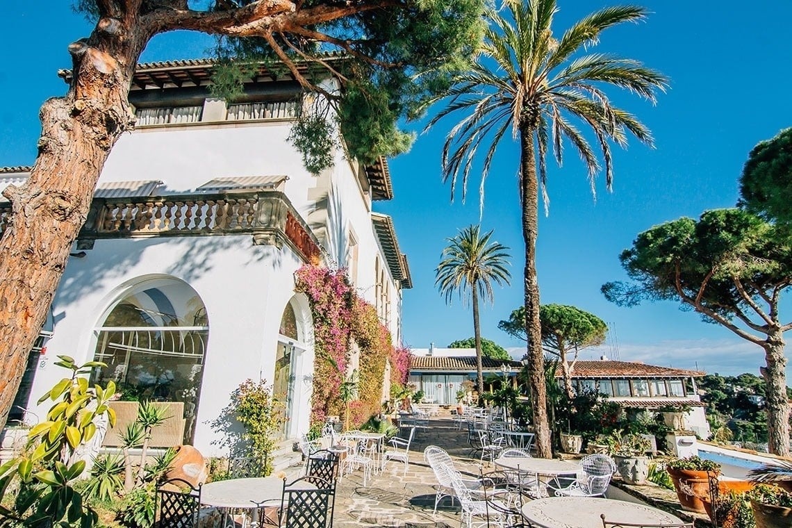 tables and chairs in a restaurant with a view of the ocean
