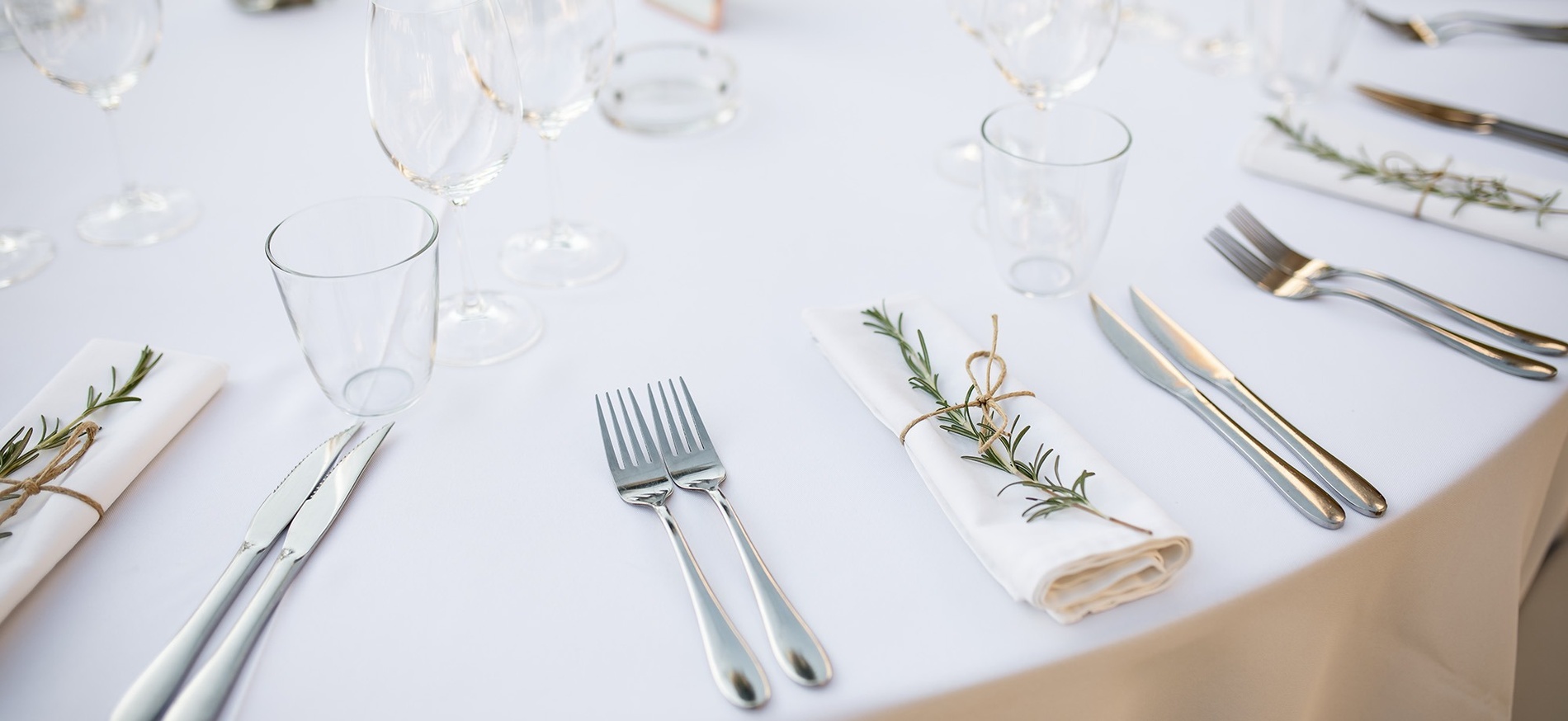 a wedding dress hangs on a balcony overlooking the ocean