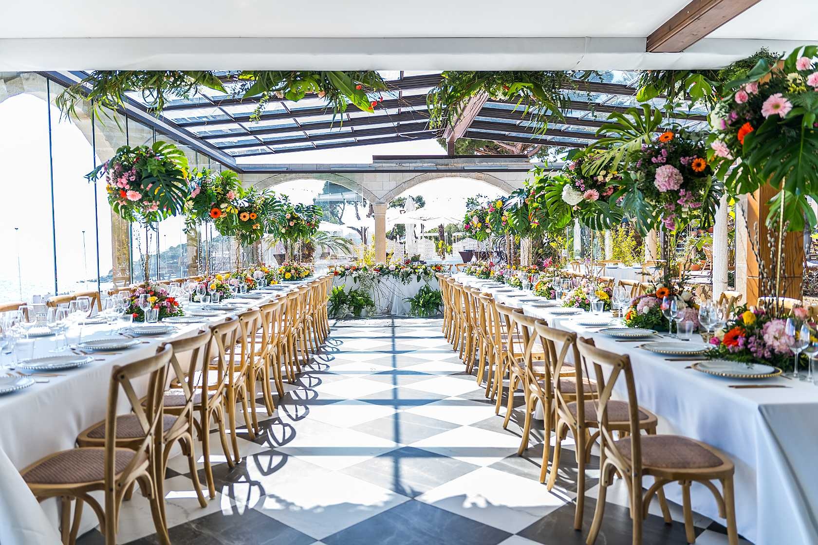 Elegant banquet setting at Roger De Flor By Seleqtta with floral decor.