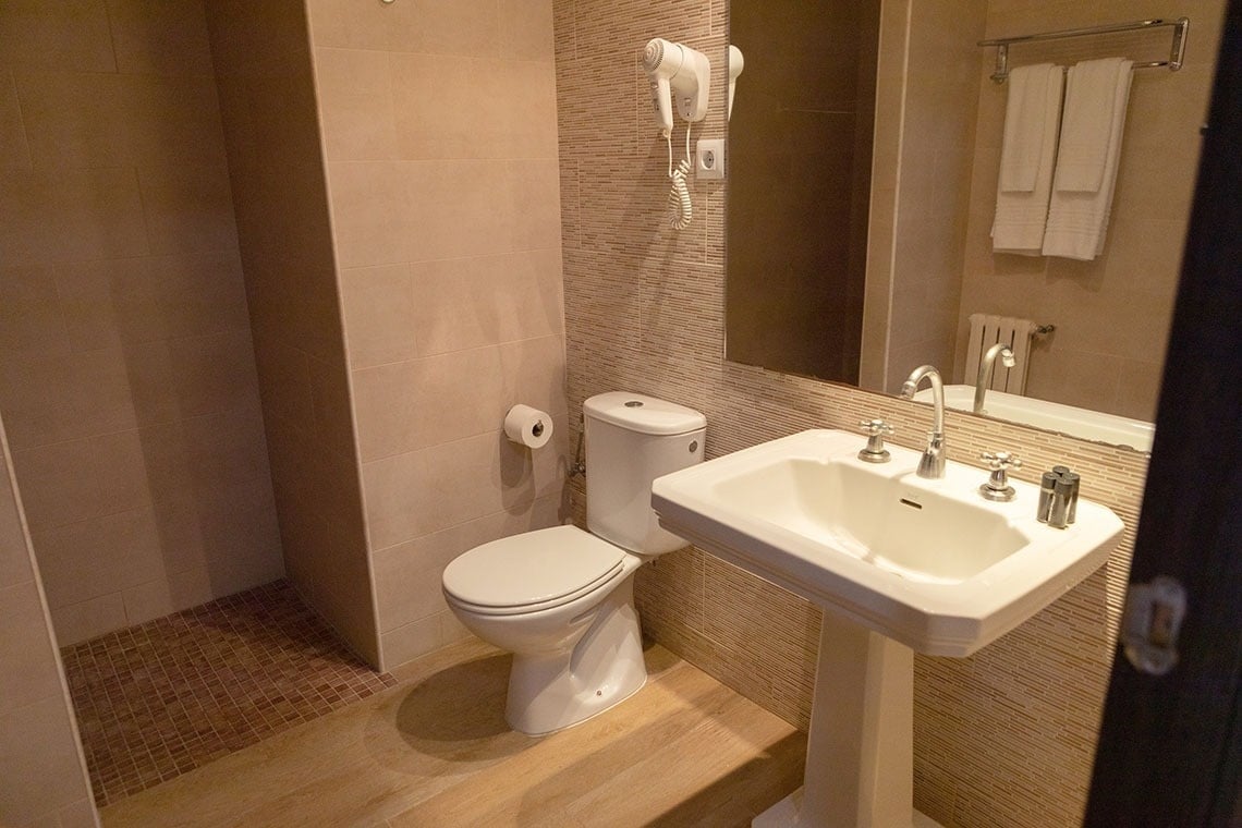 un baño con inodoro , lavabo y espejo