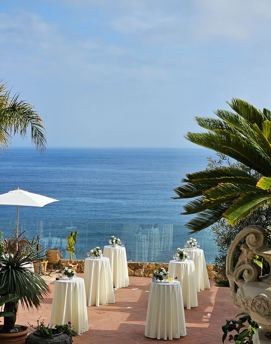 Roger De Flor By Seleqtta terrace with tables and blue sea.