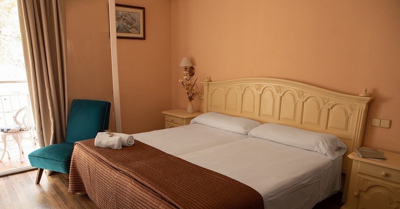 a bedroom with a bed a chair and a window