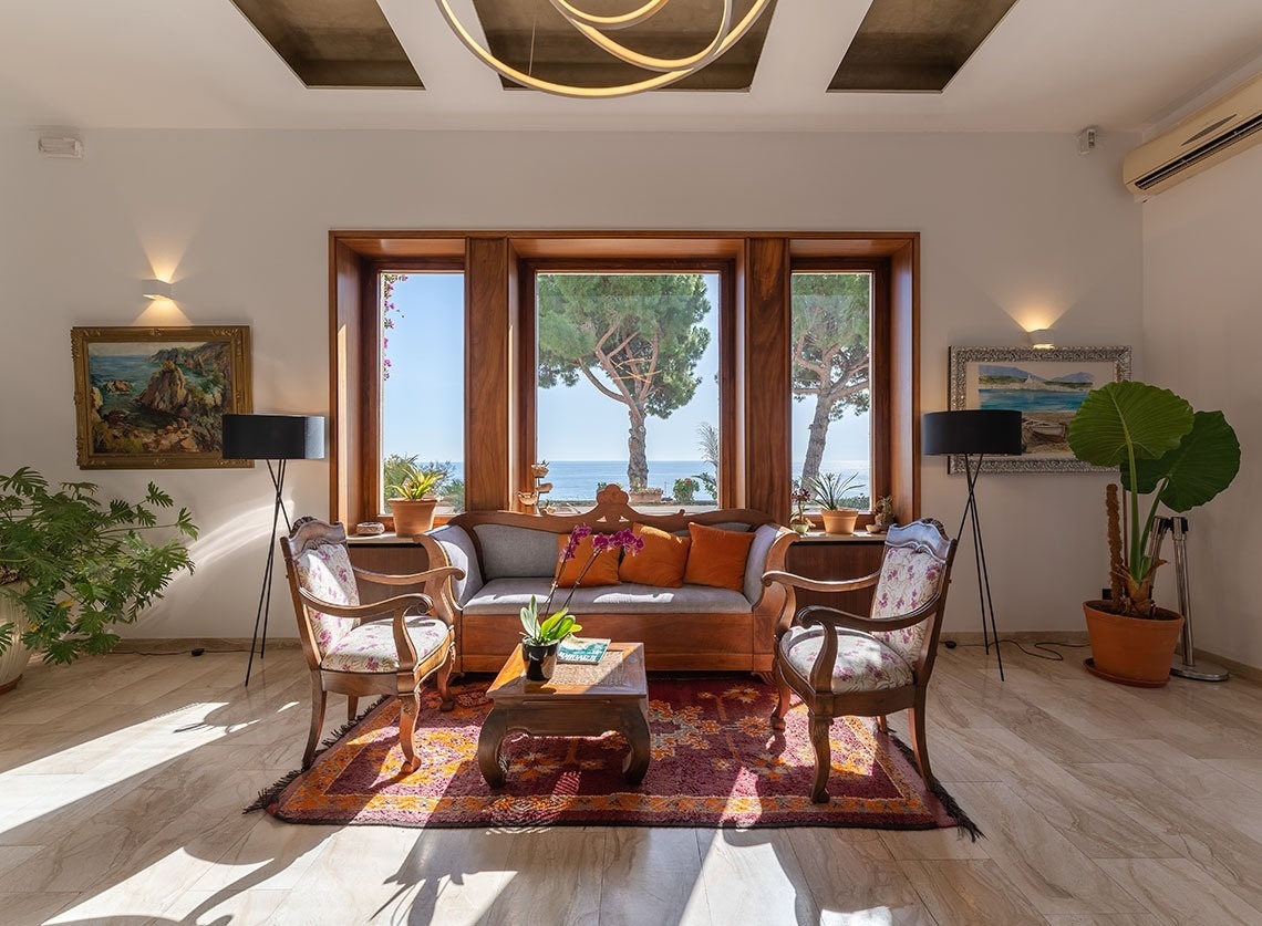 a living room with a couch and two chairs