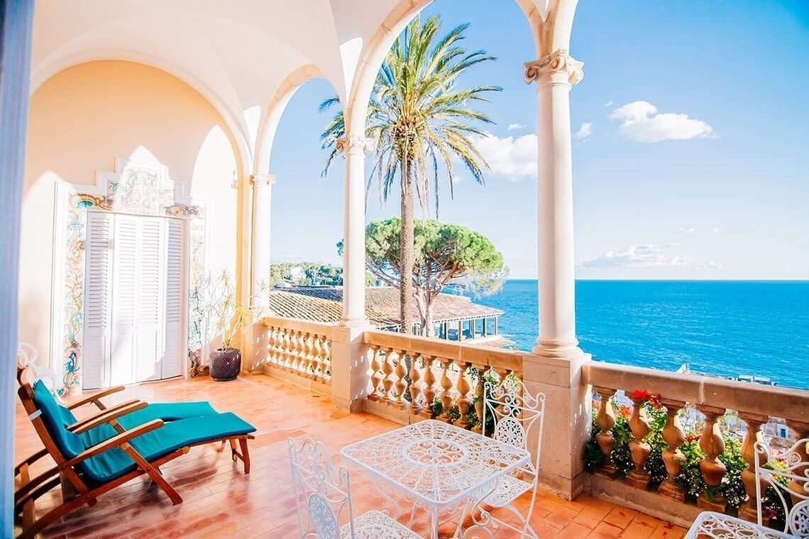 tables and chairs in a restaurant with a view of the ocean