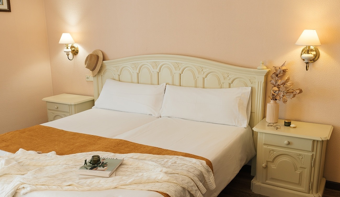 a bed with a blanket and a book on it