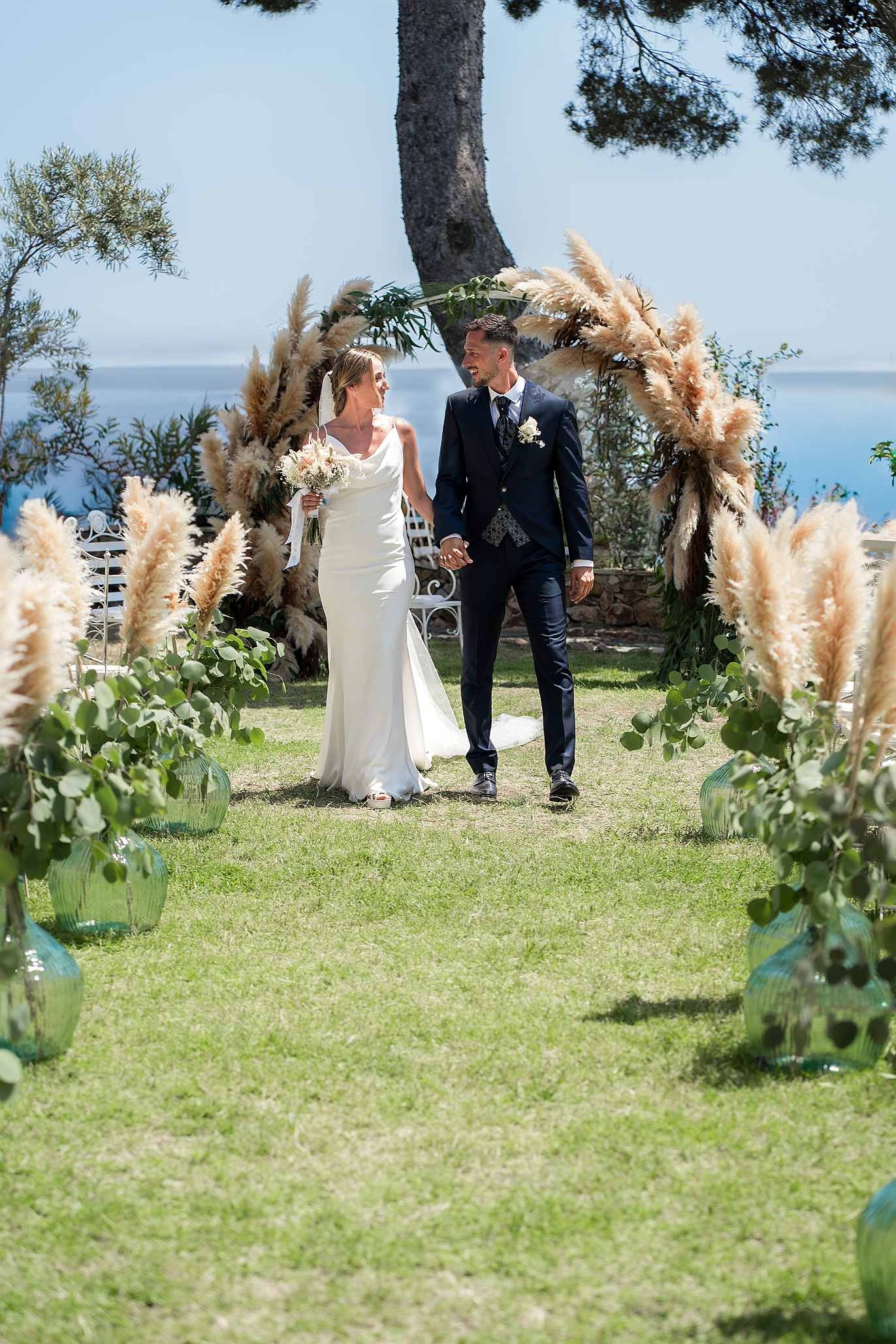 Happy newlyweds at a seaside wedding, Roger De Flor By Seleqtta.