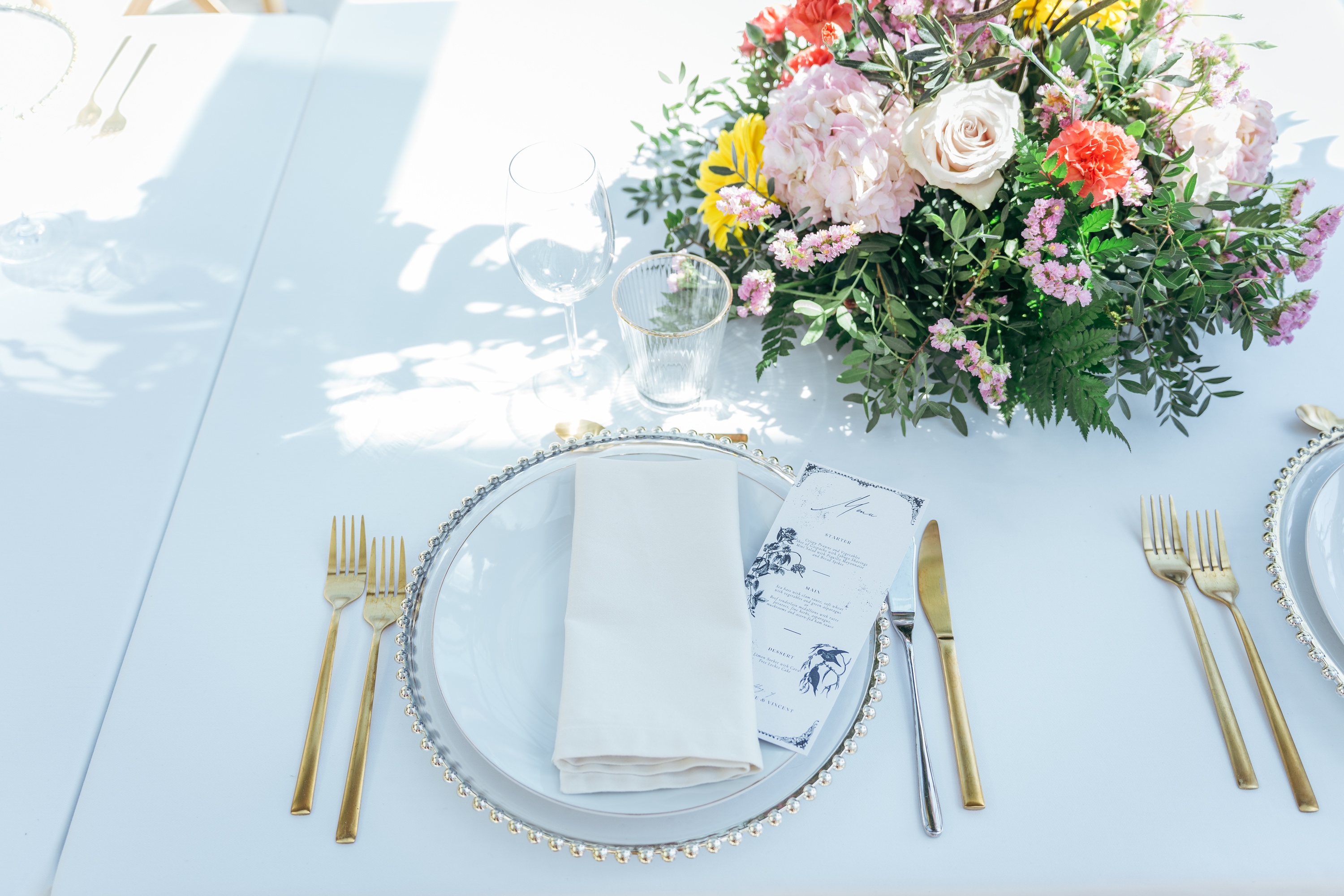 Elegant Roger De Flor By Seleqtta table setting with flowers and menu.