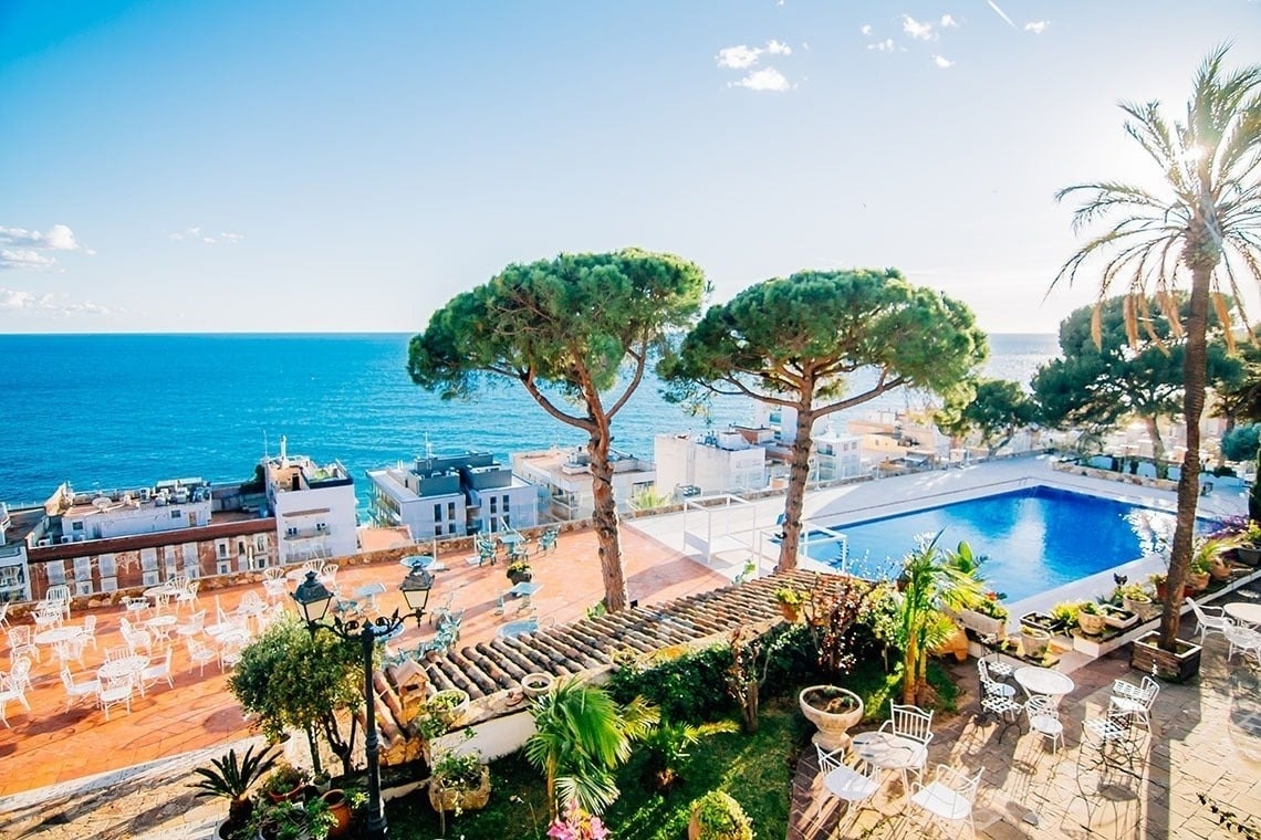 a bar with stools and bottles of liquor on shelves