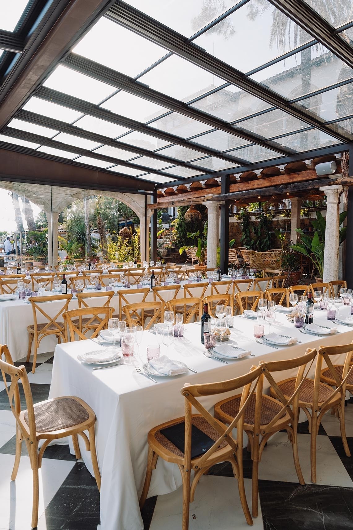 Tische und Stühle in einem Restaurant mit einem Glasdach