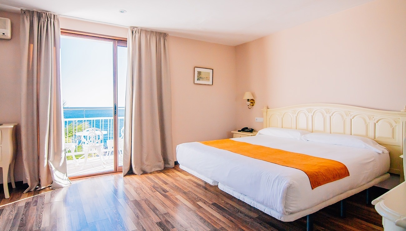 a hotel room with a large bed and a balcony