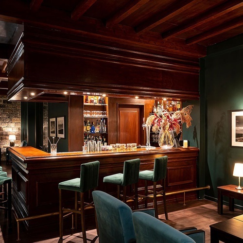 a bar with a vase of flowers on top of it