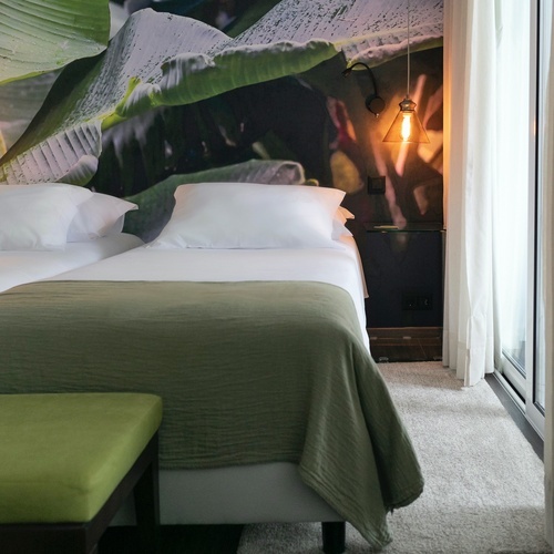 a bedroom with a bed and a green bench