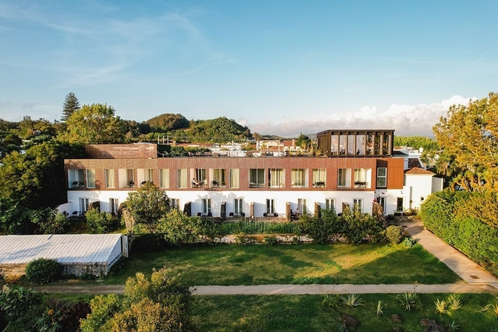 a large building with a lot of windows is surrounded by trees