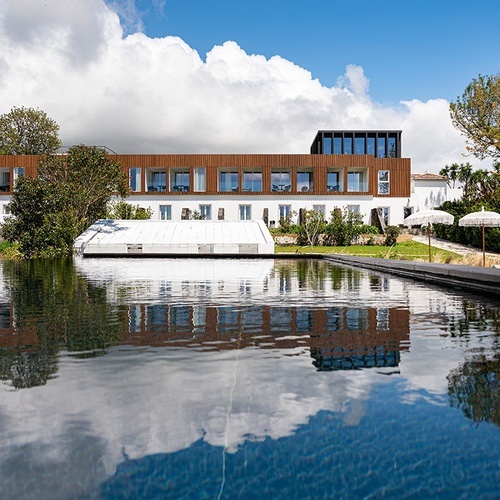 a large building with a pool in front of it