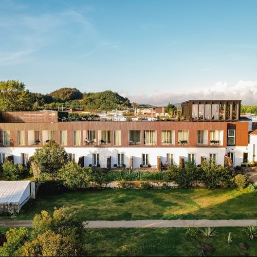 a large building with a lot of windows is surrounded by trees