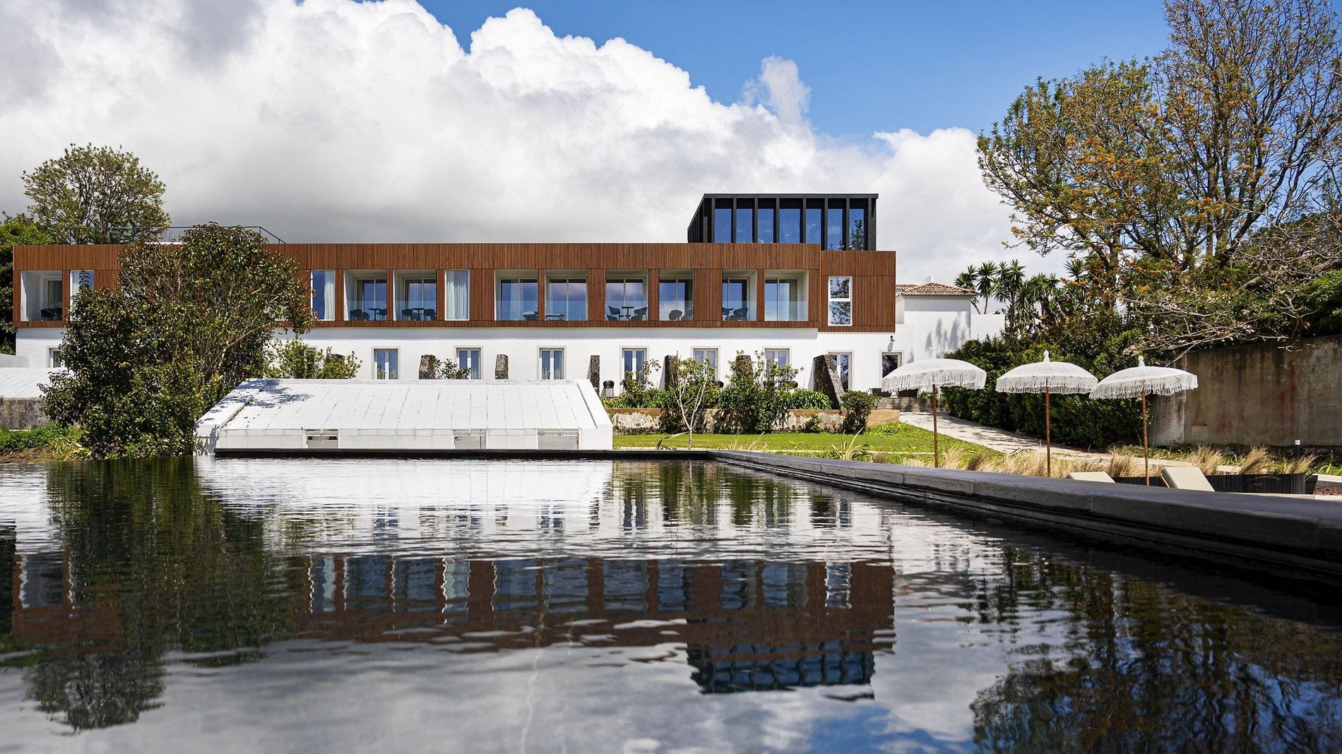 a large building with a pool in front of it