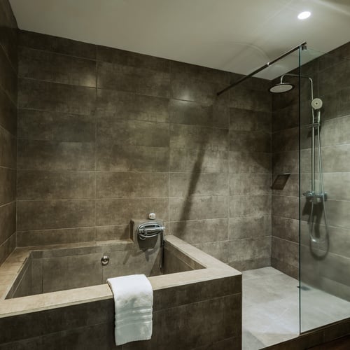 a bathroom with a toilet a sink and a trash can