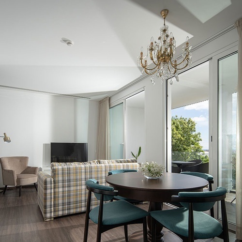 a living room with a table and chairs and a chandelier