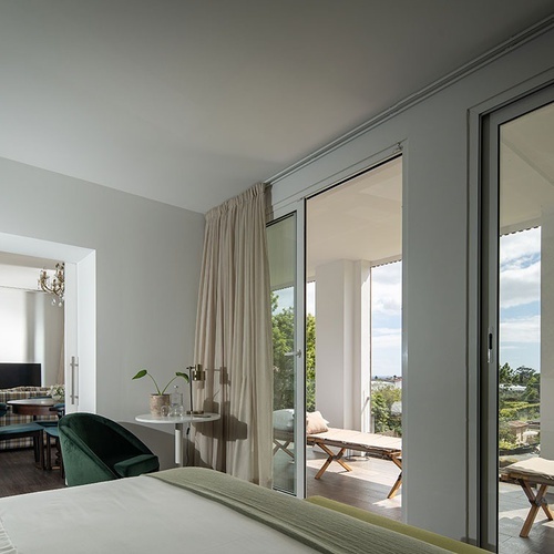 a bedroom with sliding glass doors leading to a balcony