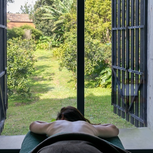 a woman laying on a towel in front of a window