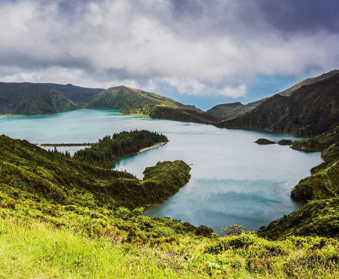 a large body of water surrounded by mountains and trees