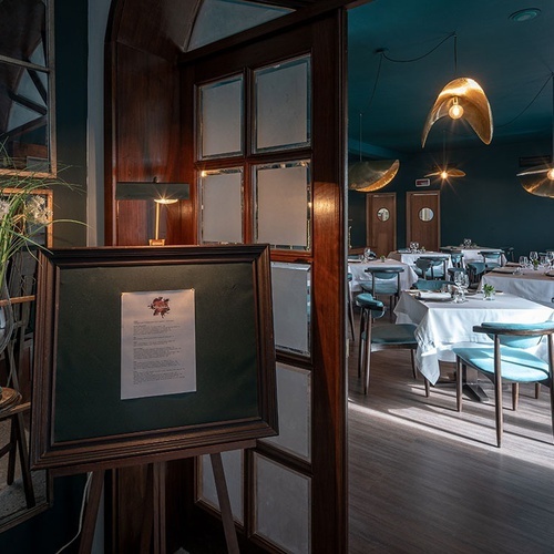 a dining room with tables and chairs and a sign that says ' menu ' on it