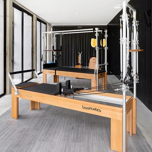 a room with a pilates machine that says doopilates