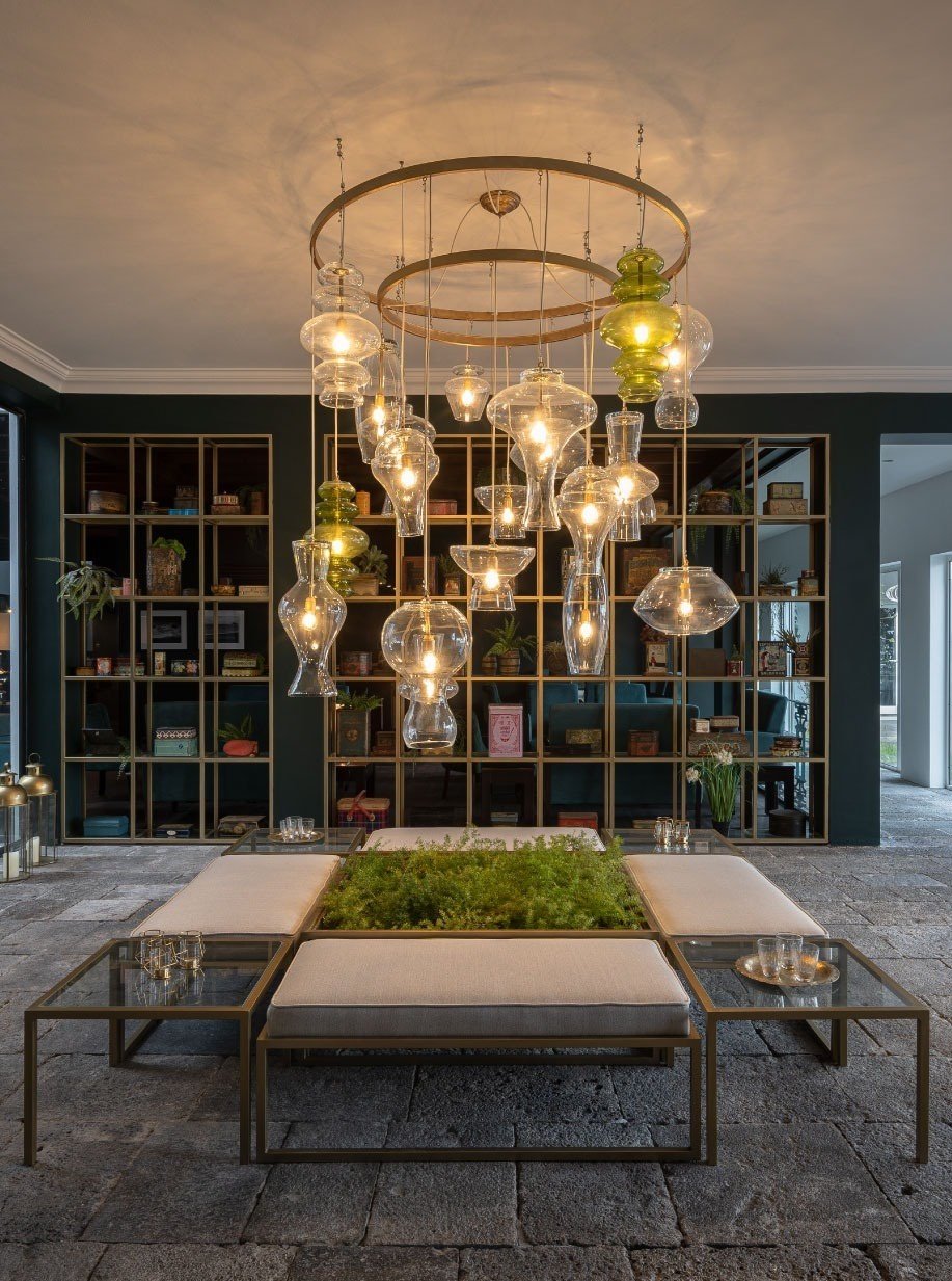 a living room with a large chandelier hanging from the ceiling