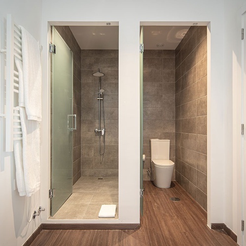 a bathroom with a toilet and a walk in shower