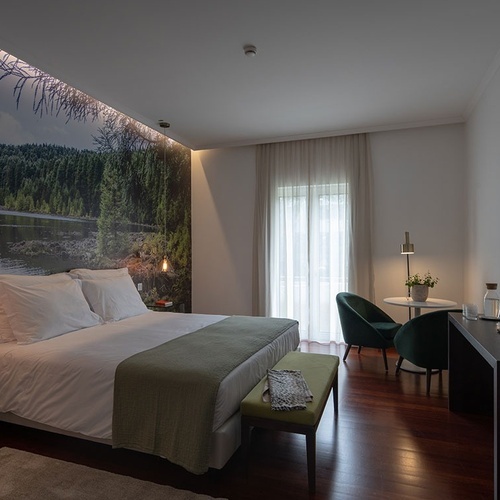 a hotel room with a large bed and a television