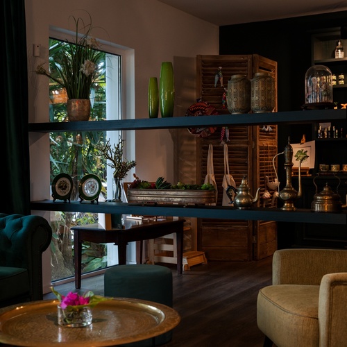 a living room with a green chair and a blue couch