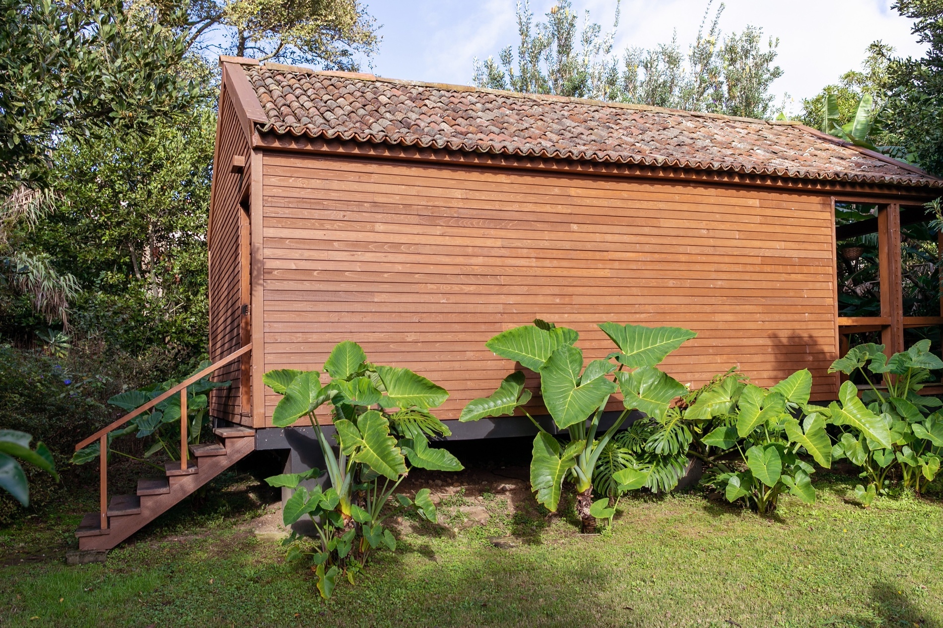 a small wooden house with stairs leading up to it