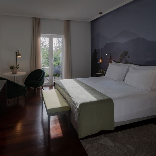 a hotel room with a bed and a television