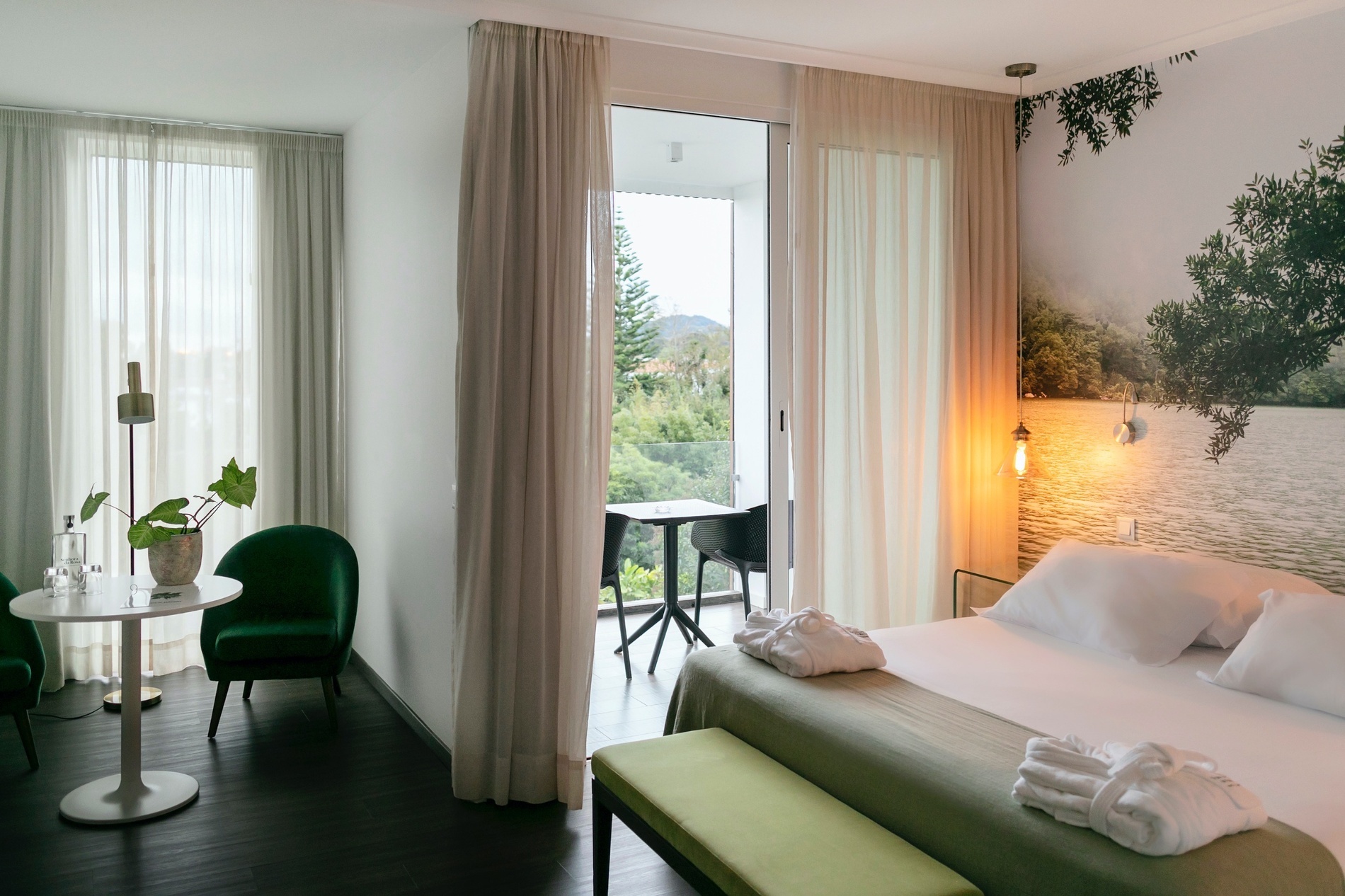 a hotel room with a large bed and a balcony