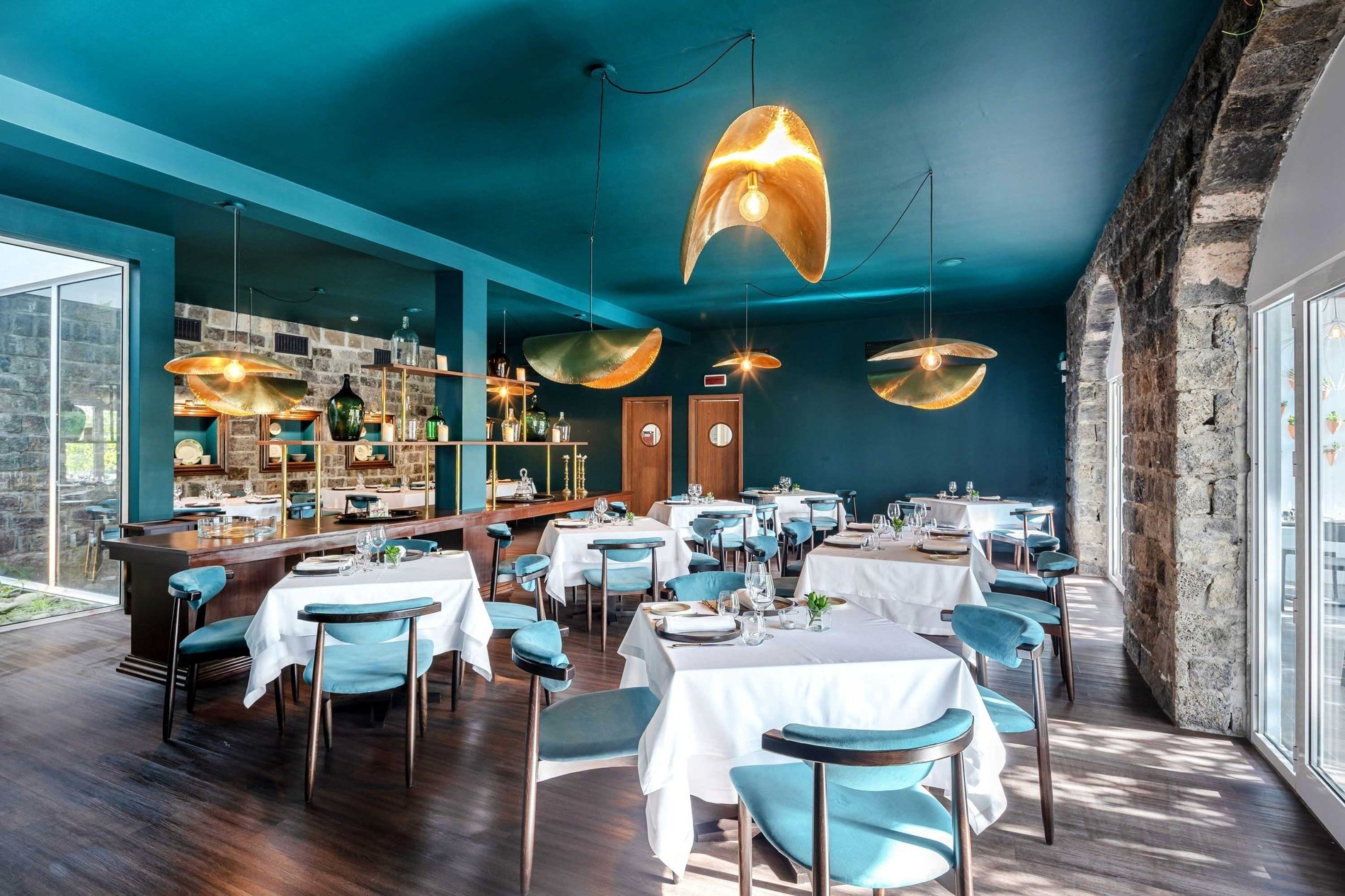 a dining room with tables and chairs and a blue ceiling