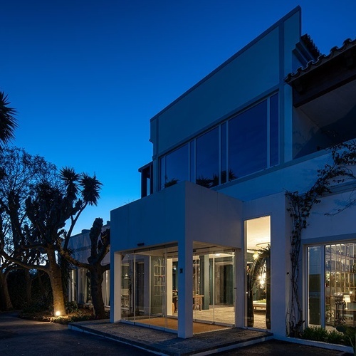a large building with a lot of windows is lit up at night