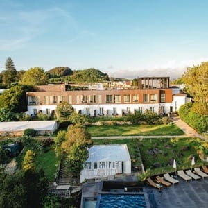 a large white building with a pool in front of it