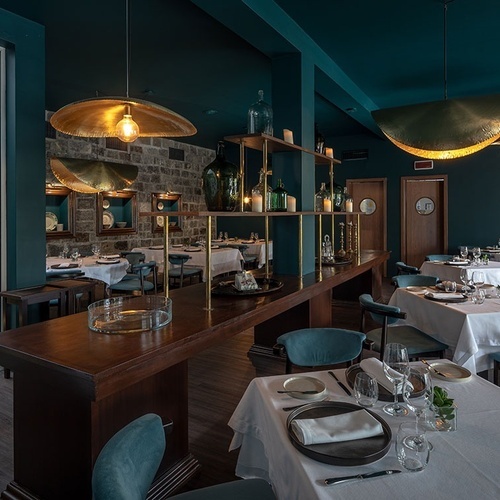 a restaurant with white tables and blue chairs