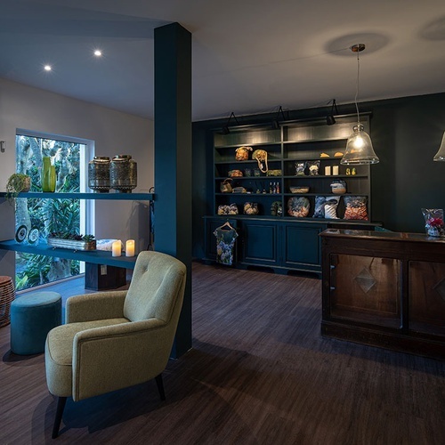 a living room with a green chair and a blue couch