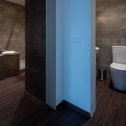 a bathroom with a toilet a sink and a trash can