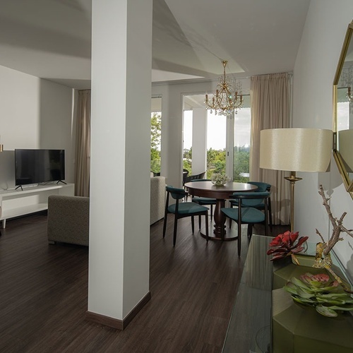 a living room with a table and chairs and a television