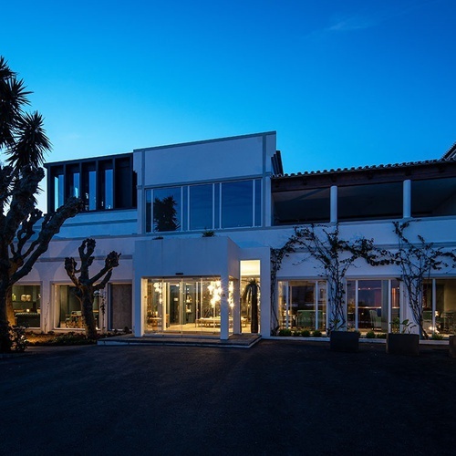 a large white building with a blue sky in the background